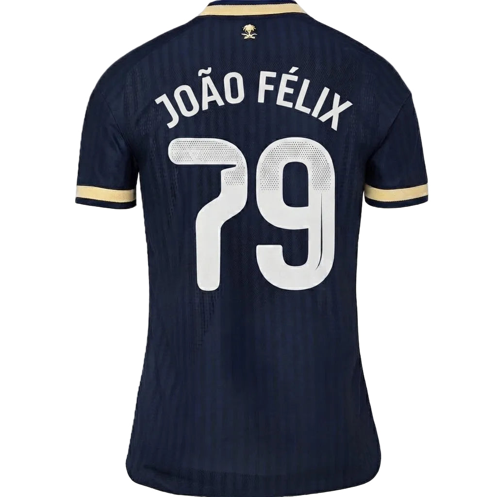 Back view of a dark navy blue soccer jersey with 'JOÃO FÉLIX' and the number '79' printed in white on the back, featuring gold and navy striped sleeve cuffs.